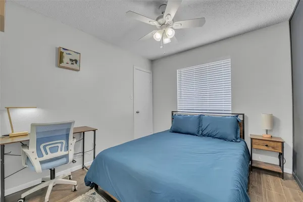 a bedroom with a bed and a chair