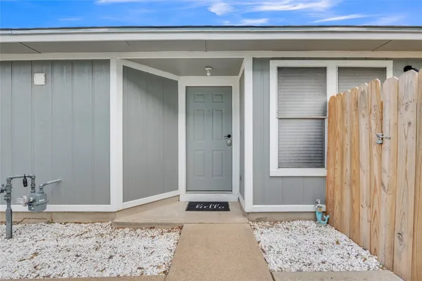 a view of a bedroom with a bed and wooden floor