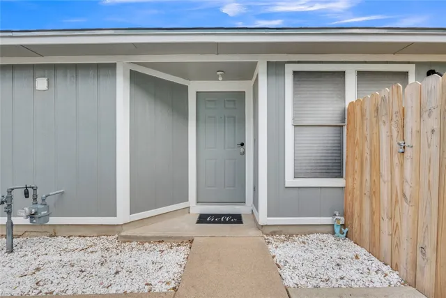 a view of a bedroom with a bed and wooden floor