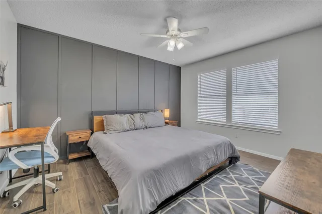 a bedroom with a bed and a chandelier