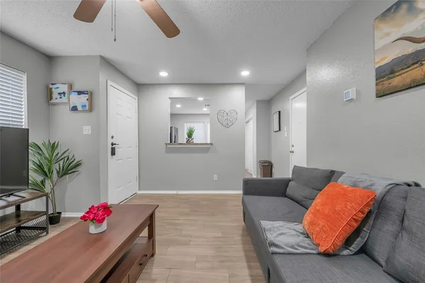 a living room with furniture potted plant and a chandelier