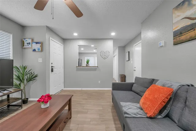 a living room with furniture potted plant and a chandelier