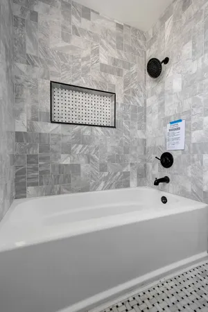 a bathroom with a bathtub and shower
