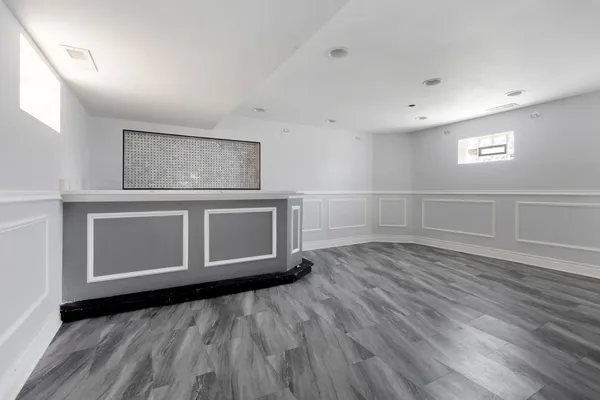 a view of a room with wooden floor and white walls