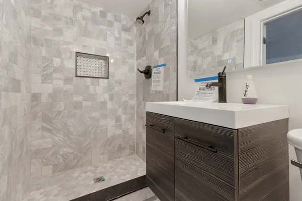 a bathroom with a sink vanity and a mirror