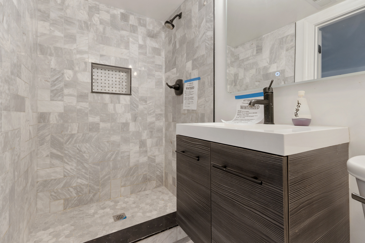 245 West 43rd Street Chicago, IL 60609 - Photo 21 of 26 a bathroom with a sink vanity and a mirror