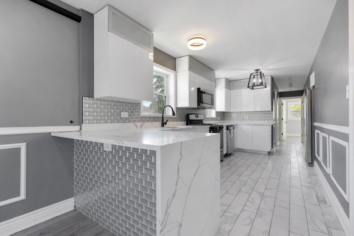 245 West 43rd Street Chicago, IL 60609 - Photo 8 of 26 a kitchen with a sink cabinets stainless steel appliances and a window
