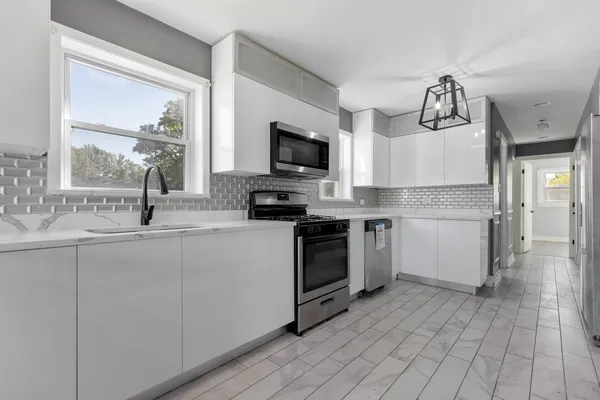 a kitchen with a sink cabinets and window