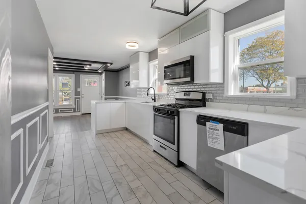 a kitchen with granite countertop a stove top oven and sink