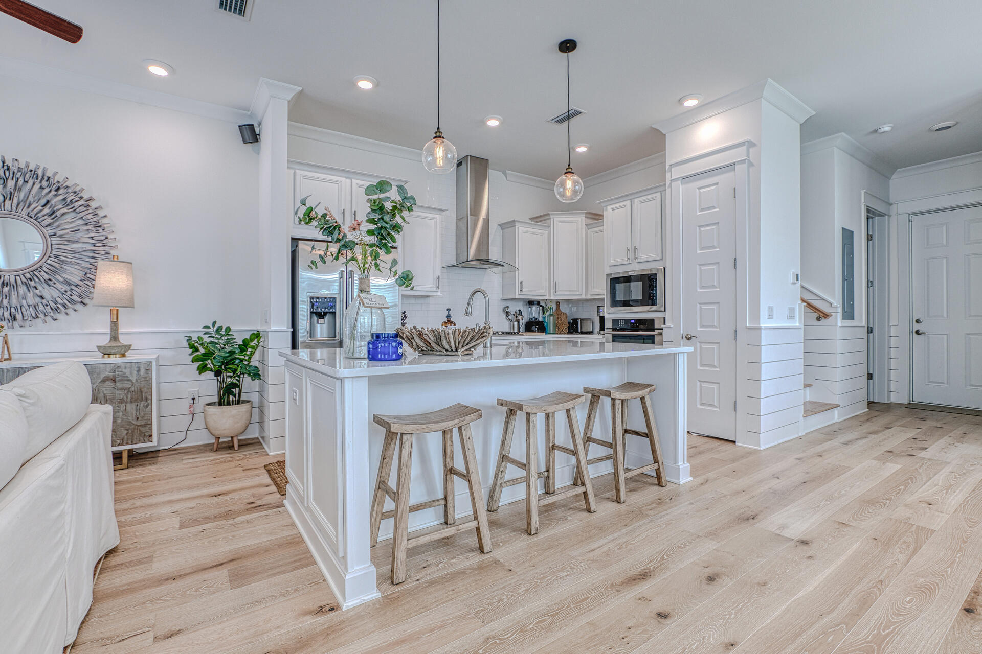 141 Pine Lands Loop Inlet Beach, Unit A Inlet Beach, FL 32461 - Photo 14 of 44 a kitchen with kitchen island stainless steel appliances a refrigerator a sink dishwasher a oven with white cabinets and wooden floor