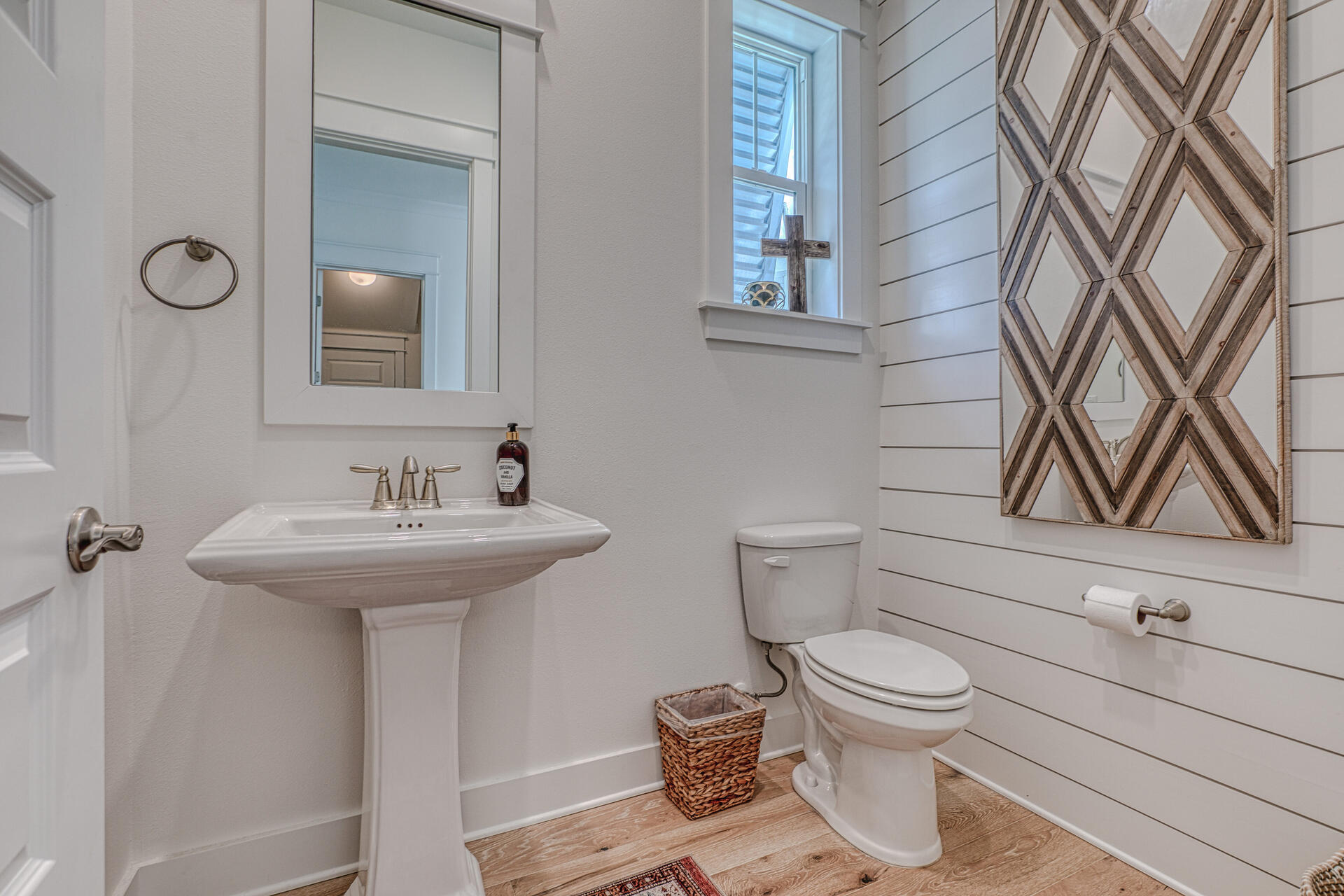 141 Pine Lands Loop Inlet Beach, Unit A Inlet Beach, FL 32461 - Photo 19 of 44 a bathroom with a sink a toilet and mirror