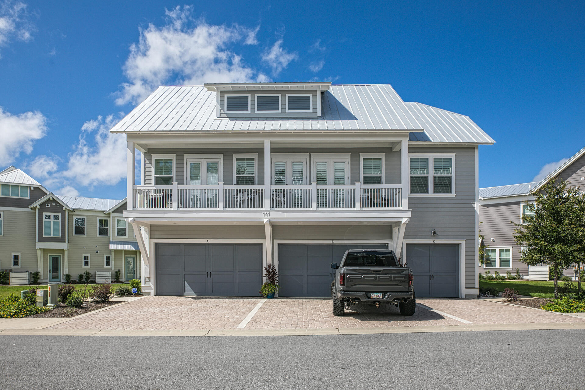 141 Pine Lands Loop Inlet Beach, Unit A Inlet Beach, FL 32461 - Photo 2 of 44 a front view of a house with a yard