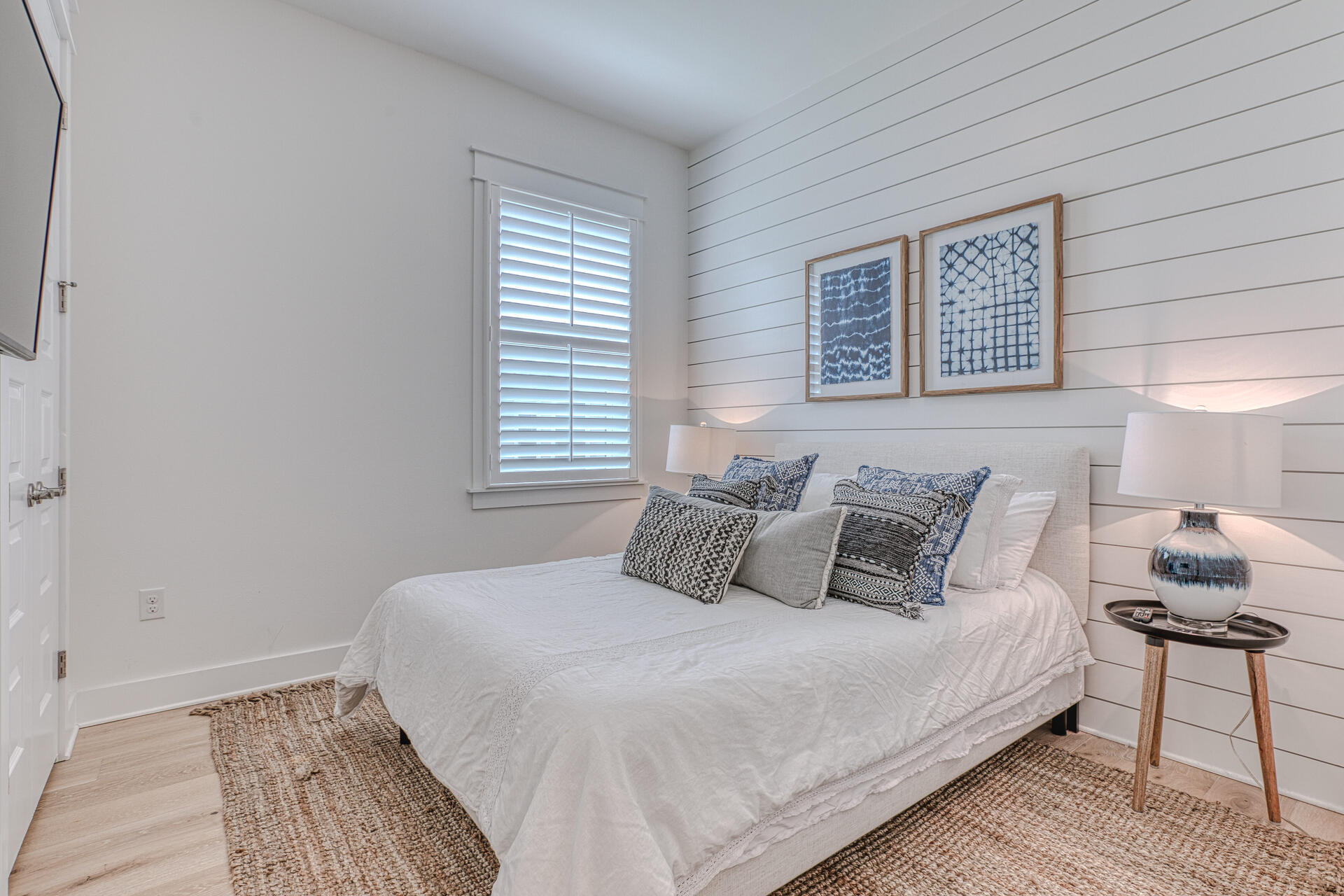 141 Pine Lands Loop Inlet Beach, Unit A Inlet Beach, FL 32461 - Photo 23 of 44 a bedroom with a bed and a lamp on dresser