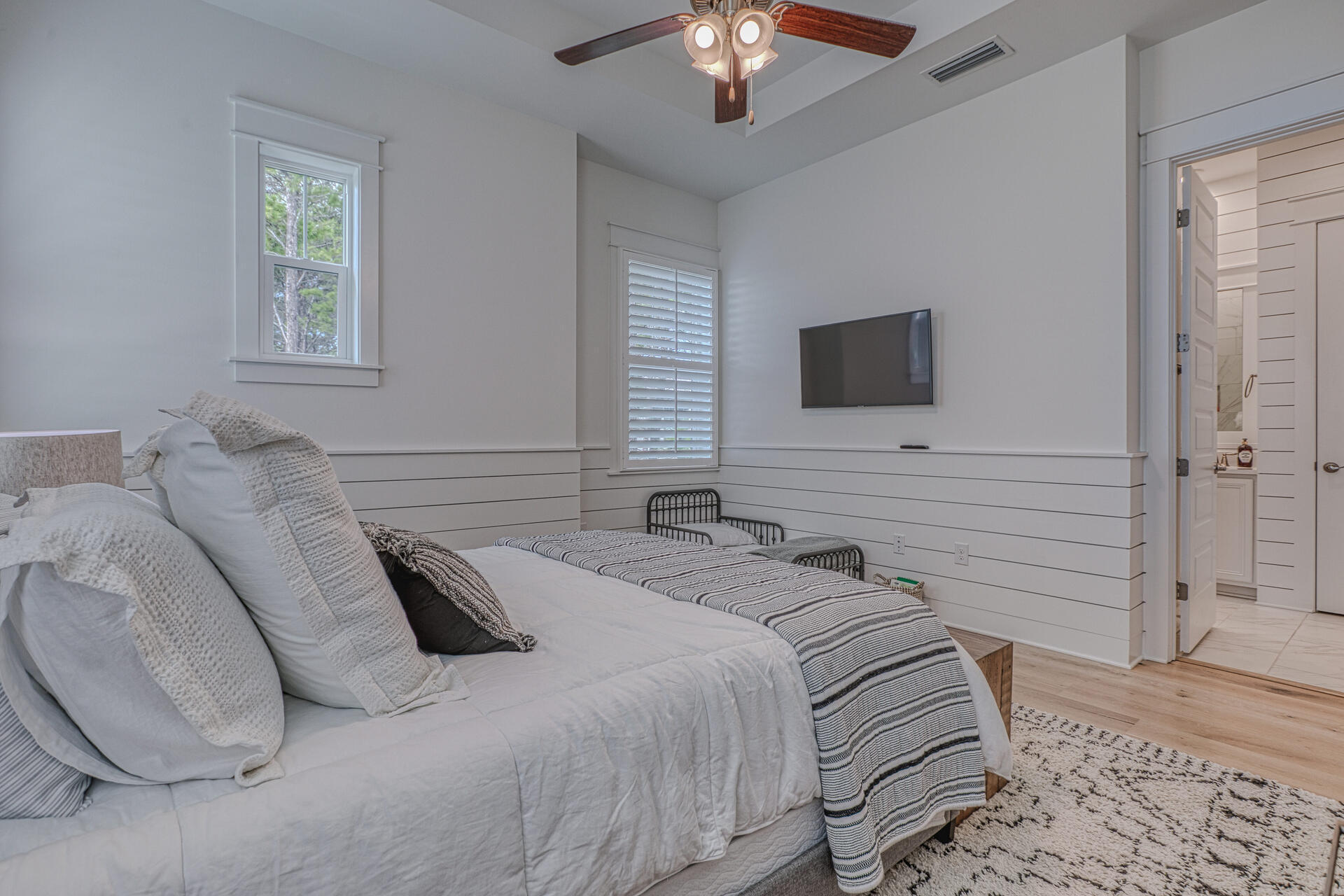 141 Pine Lands Loop Inlet Beach, Unit A Inlet Beach, FL 32461 - Photo 27 of 44 a bedroom with a bed and a flat screen tv