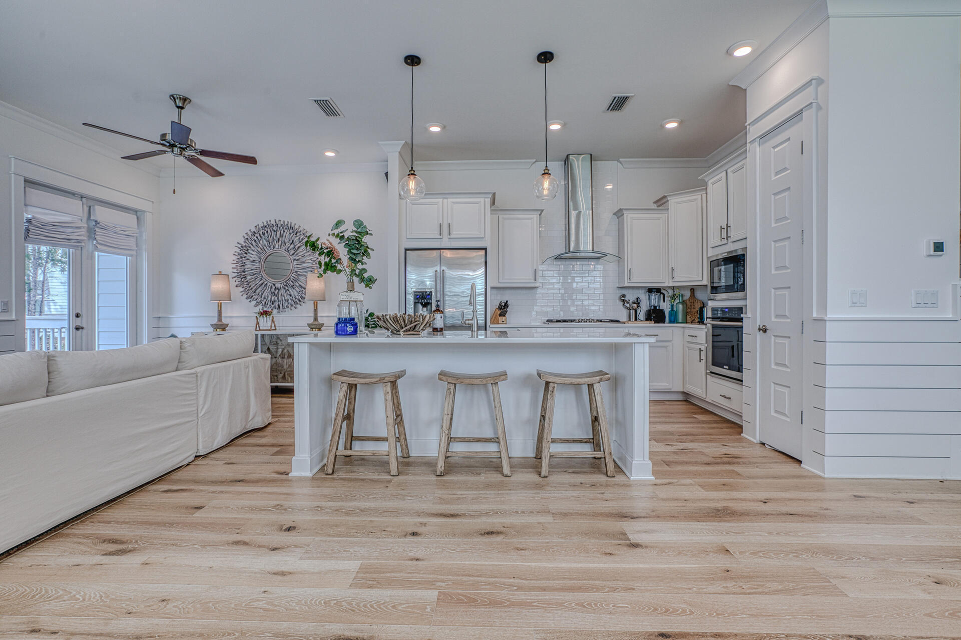 141 Pine Lands Loop Inlet Beach, Unit A Inlet Beach, FL 32461 - Photo 5 of 44 a living room with kitchen island furniture and a chandelier