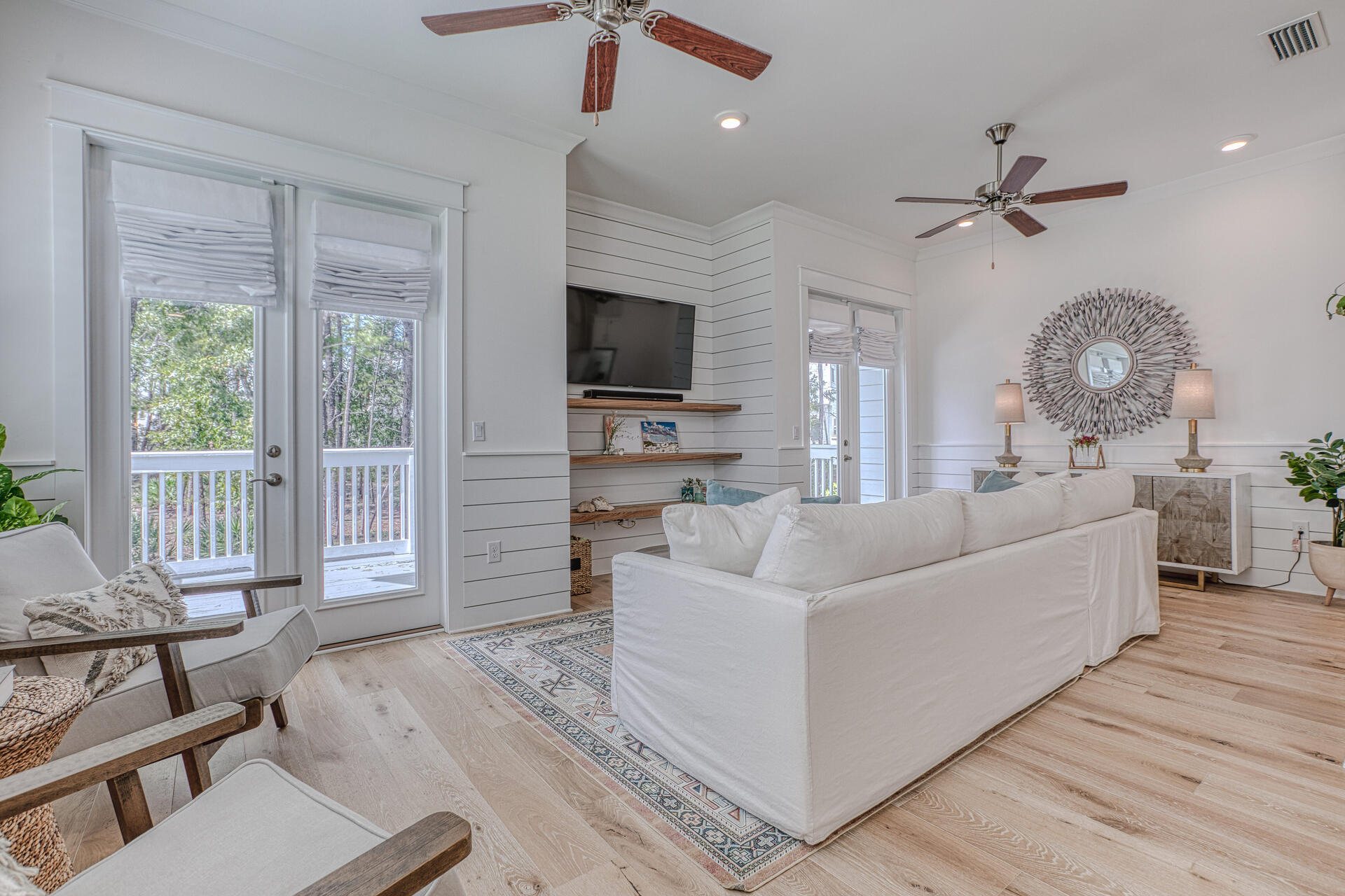 141 Pine Lands Loop Inlet Beach, Unit A Inlet Beach, FL 32461 - Photo 9 of 44 a living room with furniture a flat screen tv and a large window