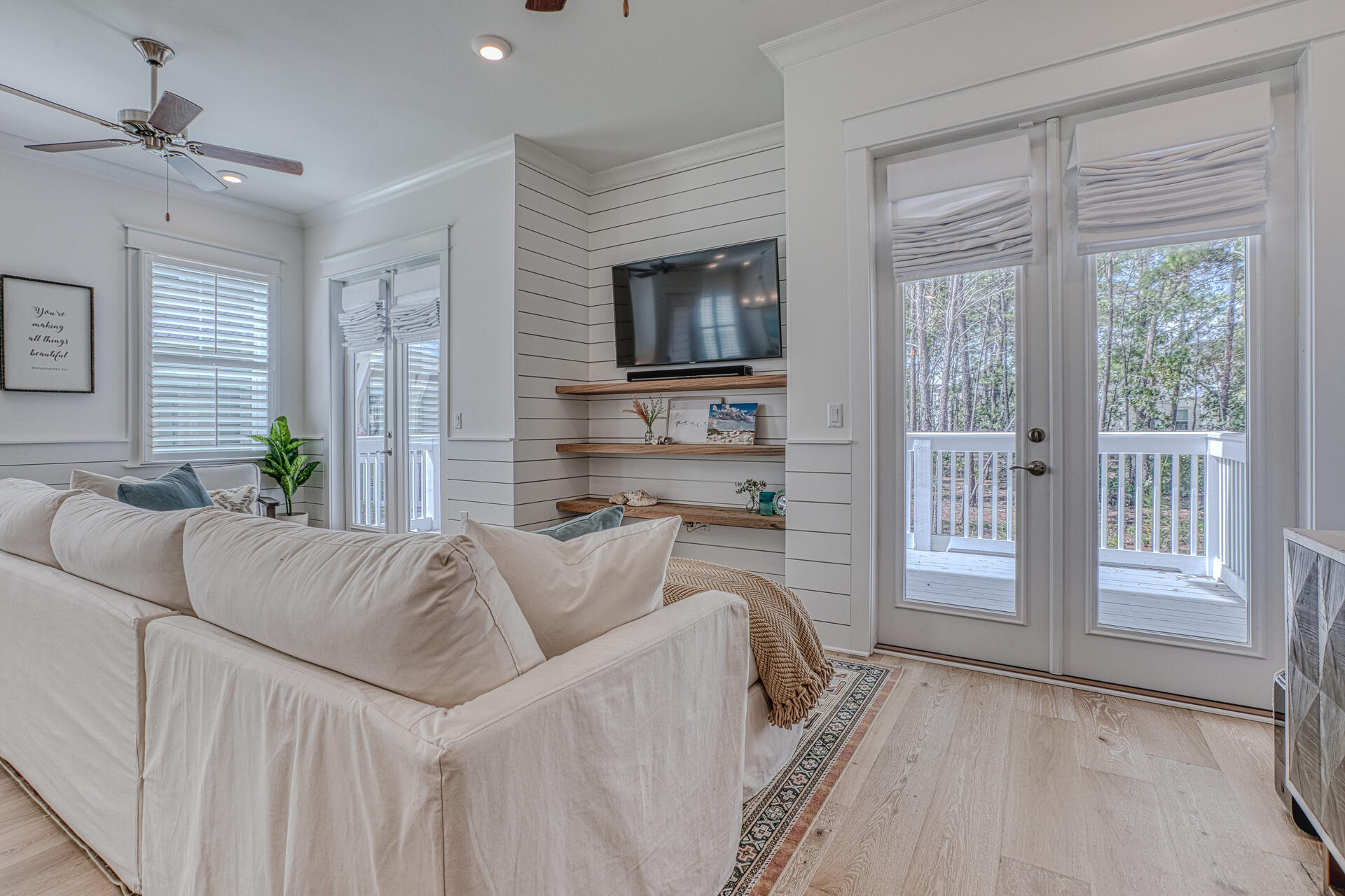 141 Pine Lands Loop Inlet Beach, Unit A Inlet Beach, FL 32461 - Photo 10 of 44 a living room with furniture a flat screen tv and a large window