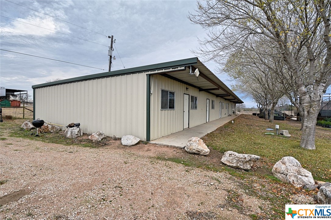 a backyard of a house with table and chairs