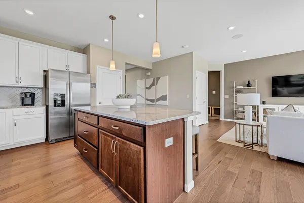 a kitchen with cabinets a counter top space stainless steel appliances and wooden floor