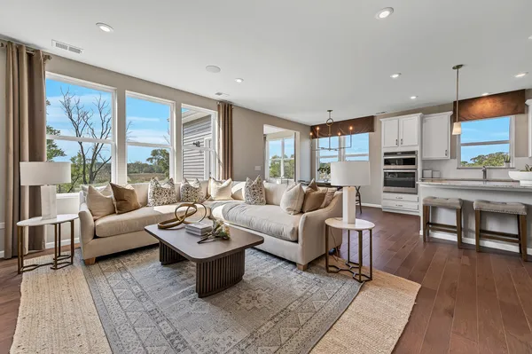 a living room with fireplace furniture and a large window