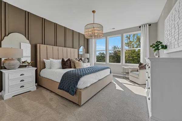 a spacious bedroom with a bed and a window