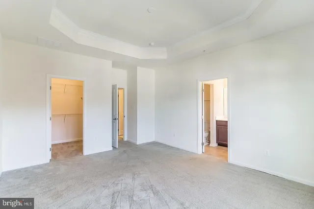 a view of an empty room and closet area