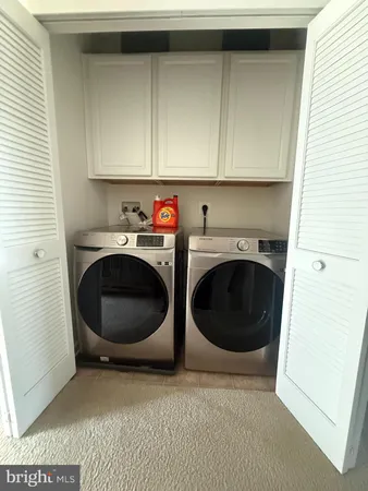 a utility room with sink dryer and washer