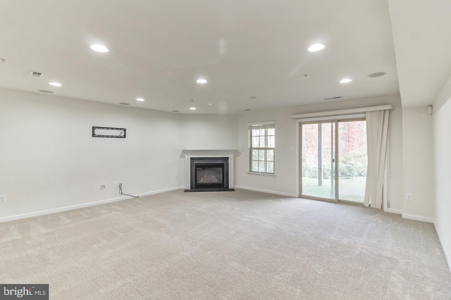 2784 Fredericksburg Road Hanover, MD 21076 - Photo 6 of 39 an empty room with windows and fireplace