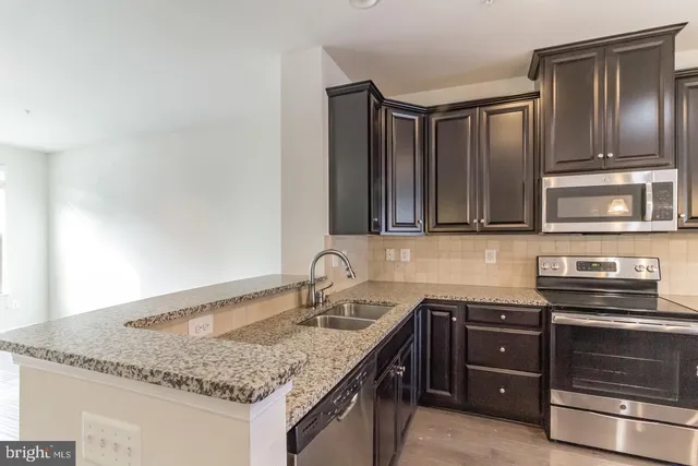 a kitchen with granite countertop stainless steel appliances and granite counter tops
