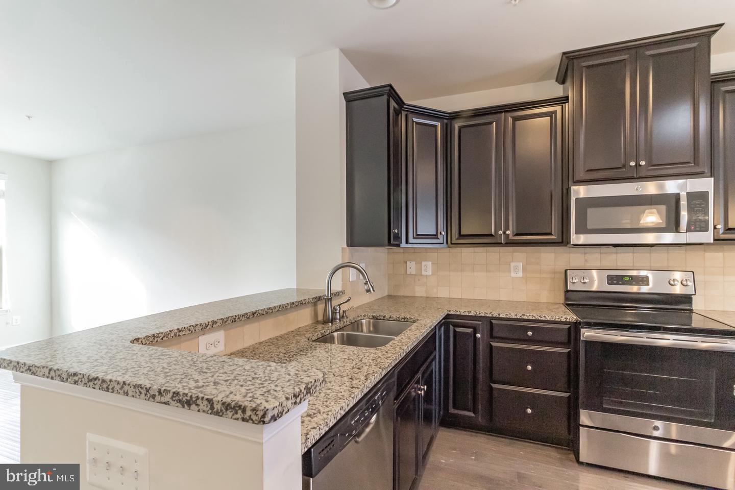 2784 Fredericksburg Road Hanover, MD 21076 - Photo 10 of 39 a kitchen with granite countertop stainless steel appliances and granite counter tops