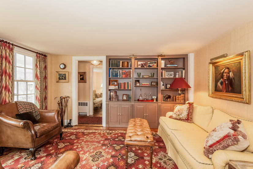 39 Brushy Ridge Road New Canaan, CT 06840 - Photo 11 of 57 a living room with furniture and a book shelf