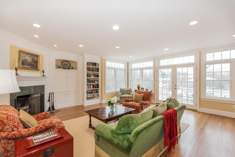 39 Brushy Ridge Road New Canaan, CT 06840 - Photo 28 of 57 a living room with furniture a large window and a fireplace