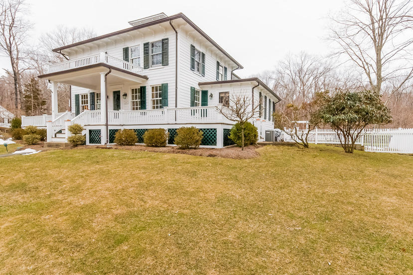 39 Brushy Ridge Road New Canaan, CT 06840 - Photo 50 of 57 a front view of a house with a yard