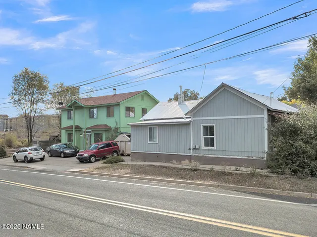 a bed room with a bed and a flat screen tv