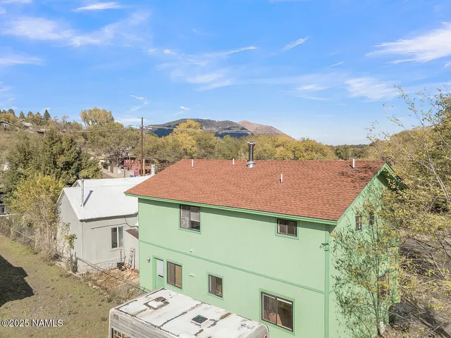 a view of a livingroom with wooden floor and staircase