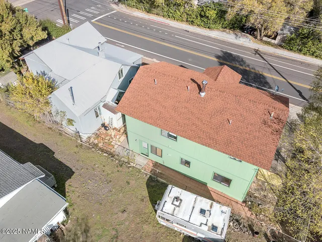 a kitchen with a stove a sink dishwasher a refrigerator with white cabinets and wooden floor