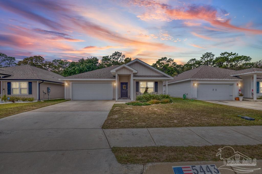 5443 Peach Drive Pace, FL 32571 - Photo 1 of 34 a front view of a house with a yard and garage