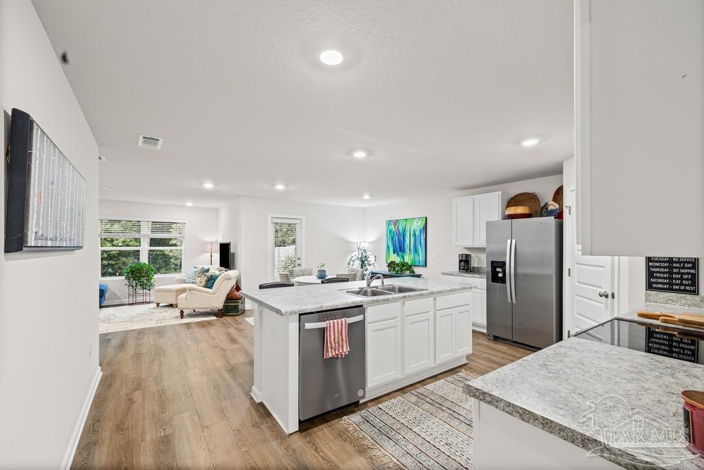 5443 Peach Drive Pace, FL 32571 - Photo 11 of 34 a kitchen with a sink a counter top space stainless steel appliances and cabinets