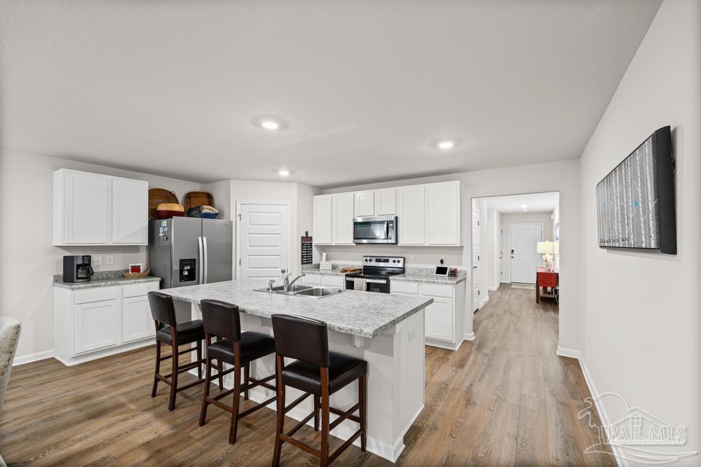 5443 Peach Drive Pace, FL 32571 - Photo 12 of 34 a view of a dining room with furniture and wooden floor