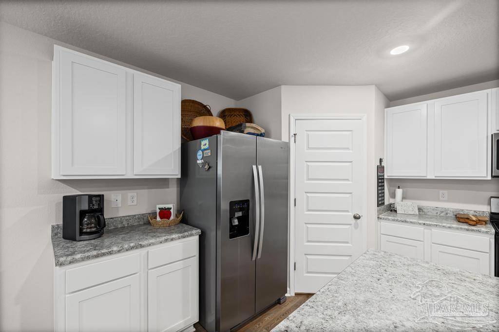 5443 Peach Drive Pace, FL 32571 - Photo 13 of 34 a kitchen with stainless steel appliances granite countertop a refrigerator and a sink