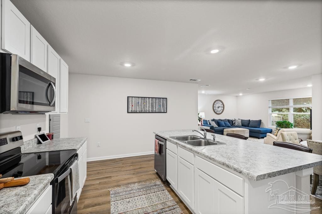 5443 Peach Drive Pace, FL 32571 - Photo 16 of 34 a view of a kitchen counter top space a sink and appliances