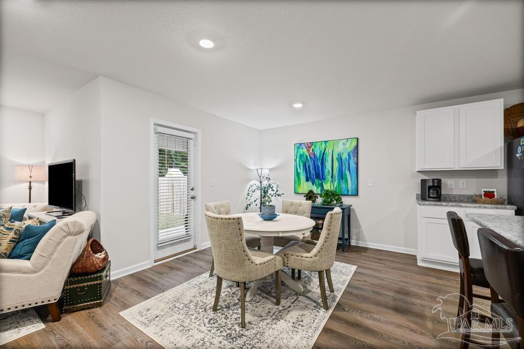 5443 Peach Drive Pace, FL 32571 - Photo 19 of 34 a view of a dining room with furniture window and wooden floor