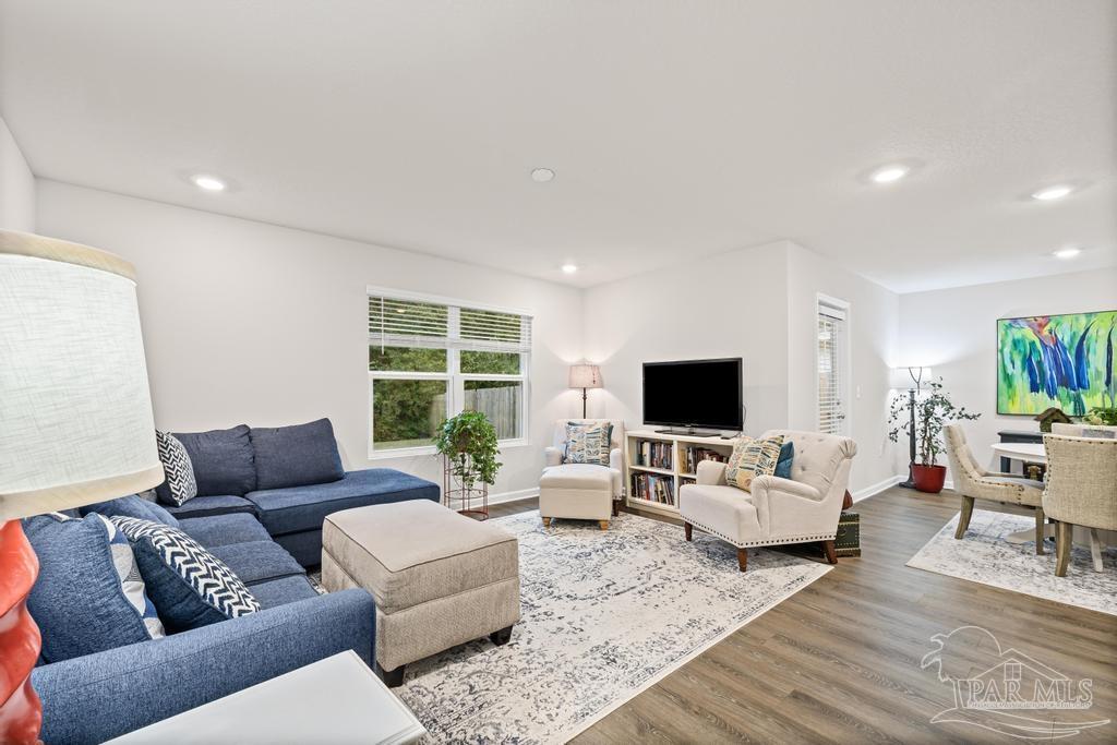5443 Peach Drive Pace, FL 32571 - Photo 20 of 34 a living room with furniture and a flat screen tv