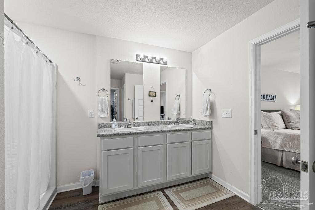 5443 Peach Drive Pace, FL 32571 - Photo 22 of 34 a en suite bathroom with a double vanity sink and a mirror