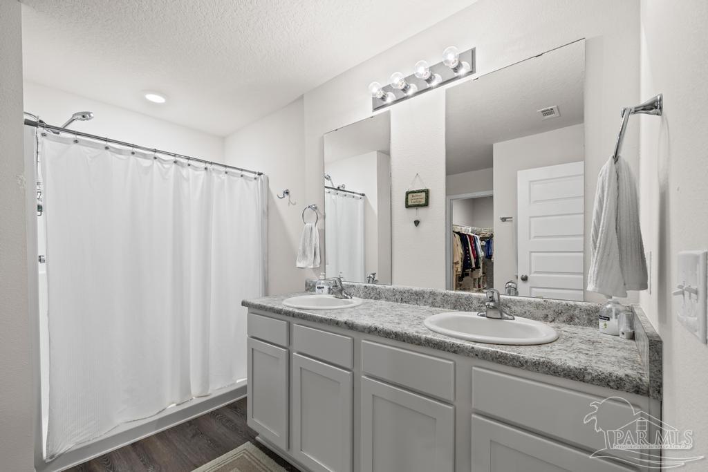 5443 Peach Drive Pace, FL 32571 - Photo 23 of 34 a bathroom with a granite countertop sink shower and a mirror