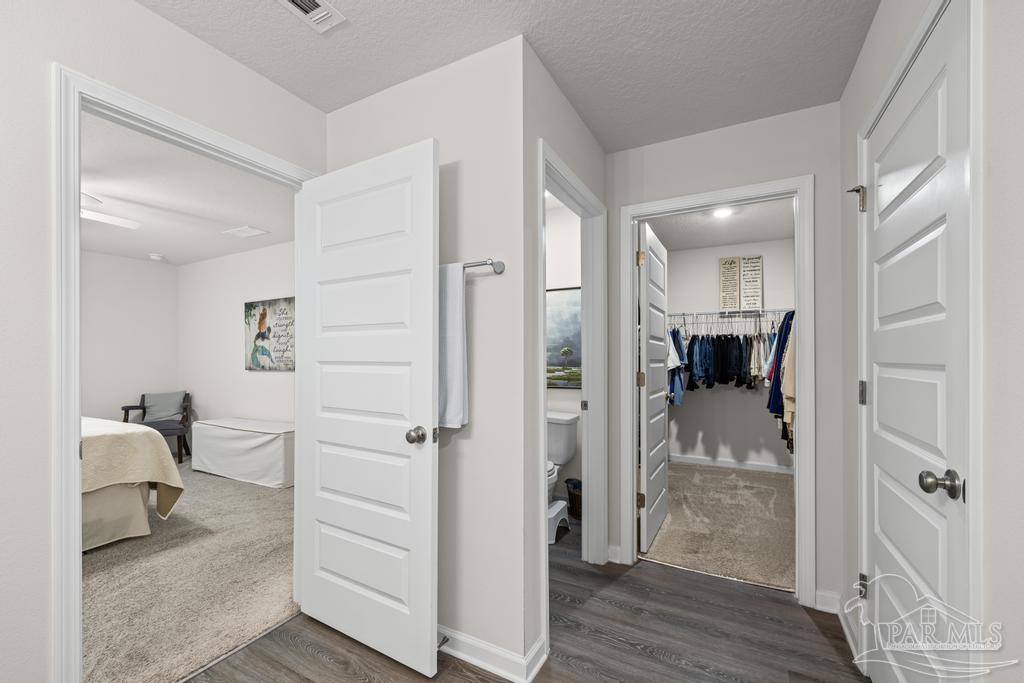 5443 Peach Drive Pace, FL 32571 - Photo 24 of 34 a view of a hallway with a livingroom and furniture