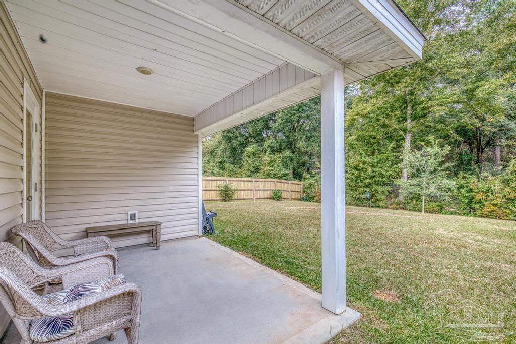 5443 Peach Drive Pace, FL 32571 - Photo 30 of 34 a view of a backyard with plants and garden