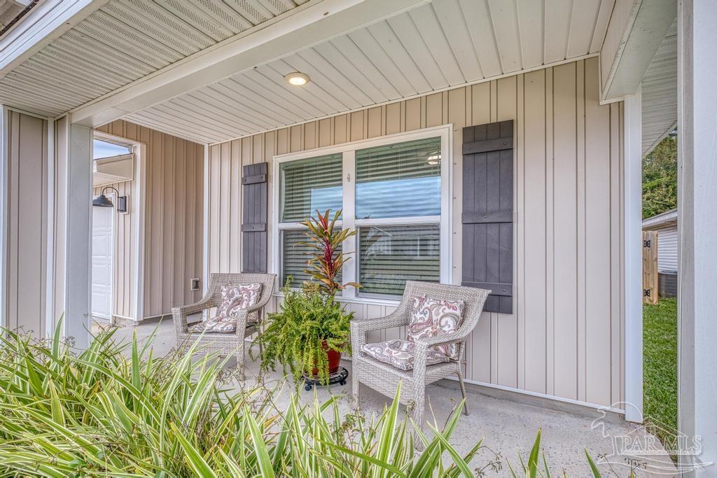5443 Peach Drive Pace, FL 32571 - Photo 3 of 34 an outdoor view of patio with plants