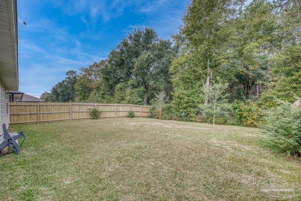 5443 Peach Drive Pace, FL 32571 - Photo 4 of 34 a view of a field of grass and trees