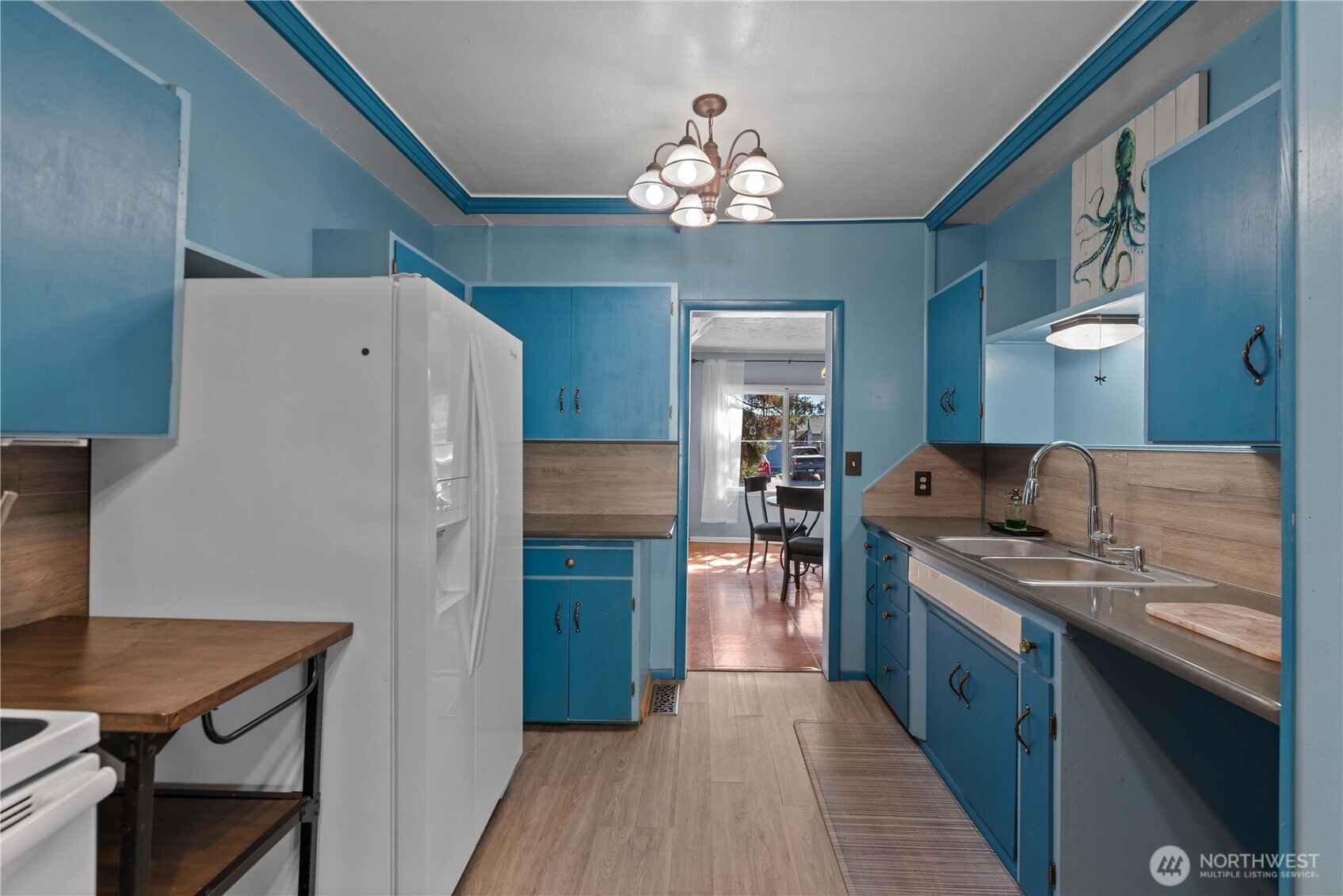 22 South Emerson Avenue Wenatchee, WA 98801 - Photo 23 of 38 a kitchen with stainless steel appliances granite countertop a refrigerator a sink dishwasher and a stove with wooden floor